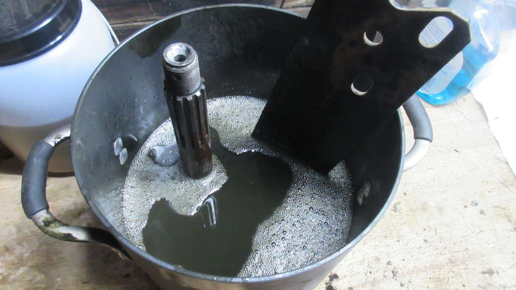 Stub Axle and Spring Plate soaking in mineral spirits